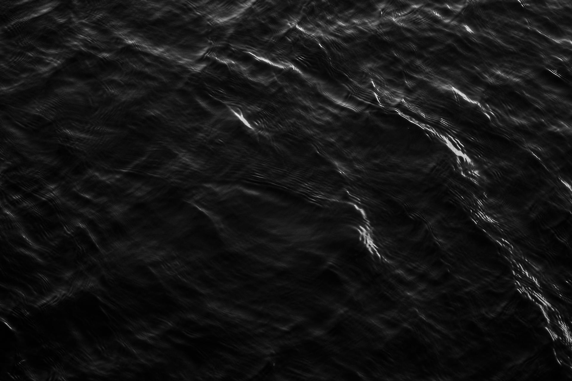 Abstract monochrome texture of ocean waves showing natural patterns.