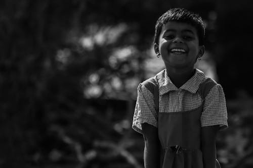 Black and White Photo of a Kid Smiling