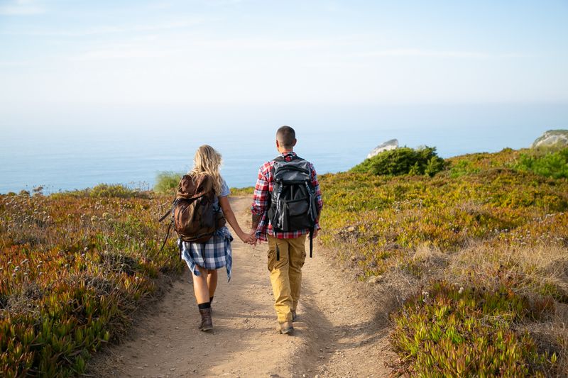 Two friends hiking a seaside trail — photo by Kampus Production on Pexels