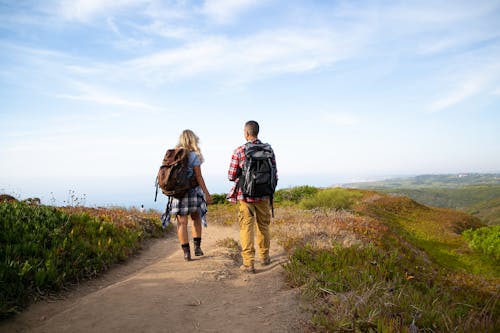 Back View of Woman and Man on Footpath