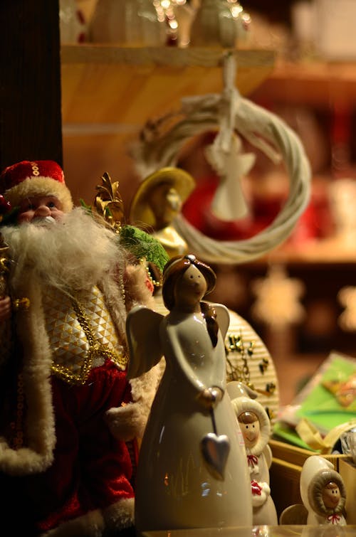 Santa Claus and Angel Figurine in Close-up Photography