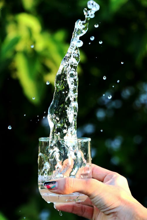 Free Woman Splashing Water from a Glass  Stock Photo