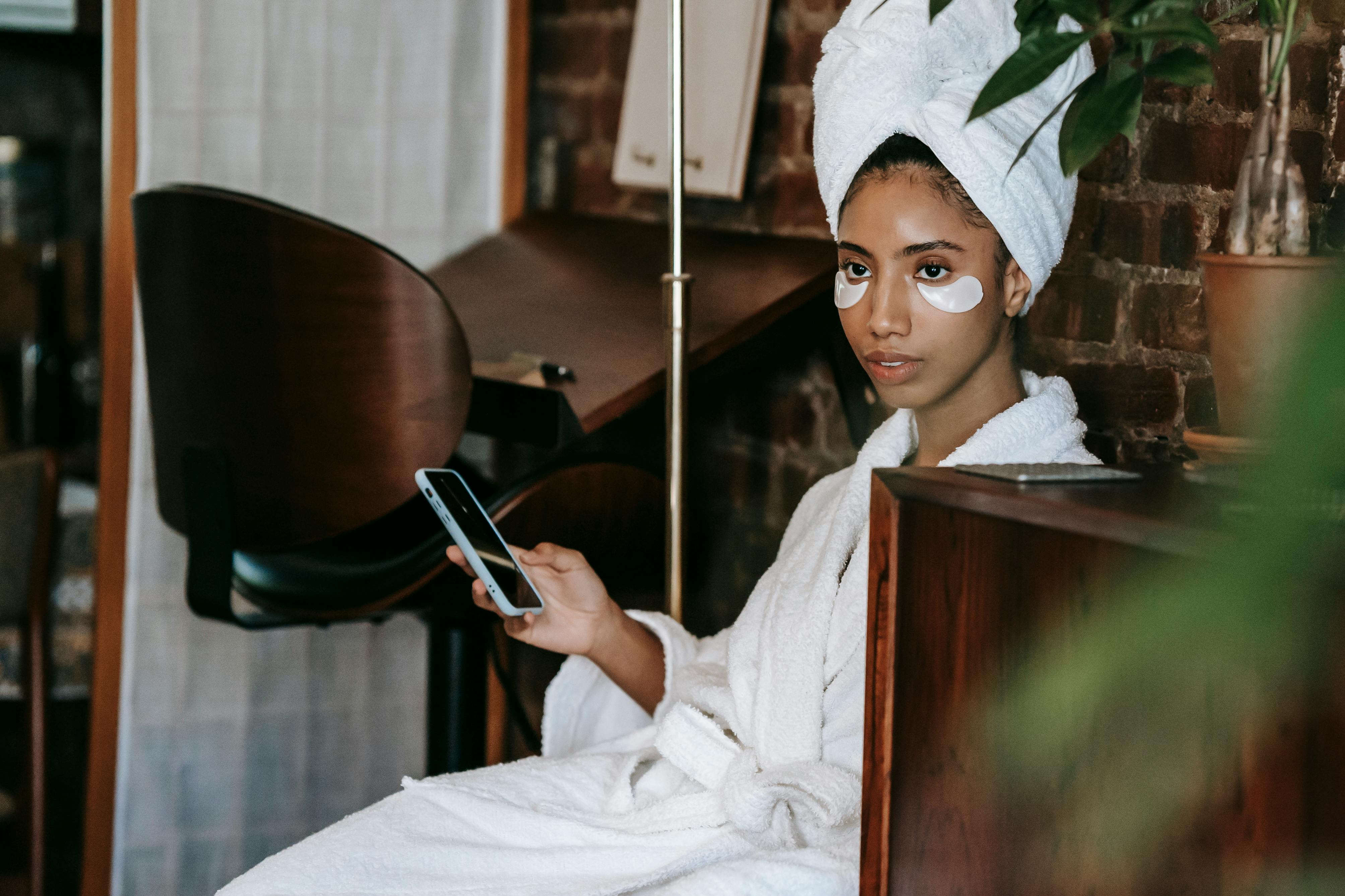 Charming ethnic woman with smartphone and eye patches \u00b7 Free Stock Photo