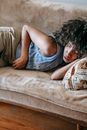 Young ethnic woman sleeping on couch