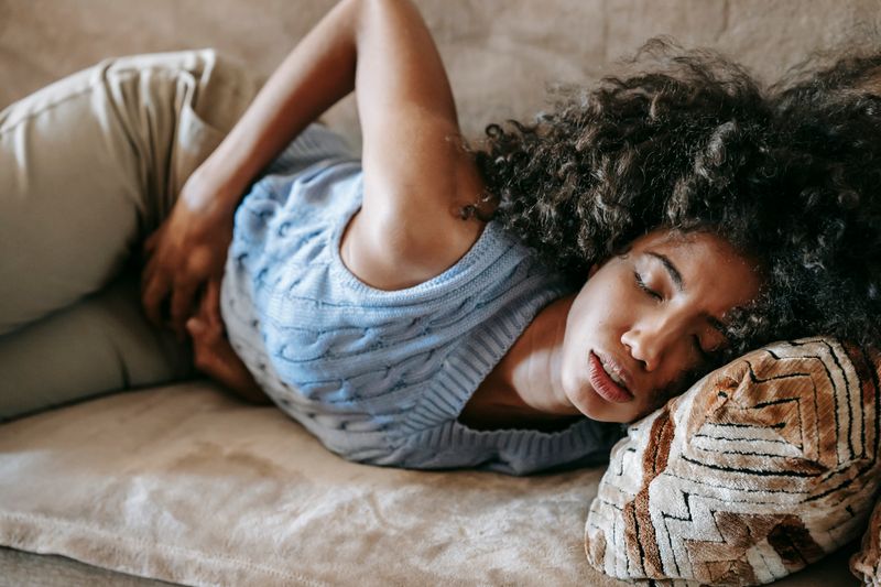 Black African person in visible stomach pain – peptic ulcer Nigeria