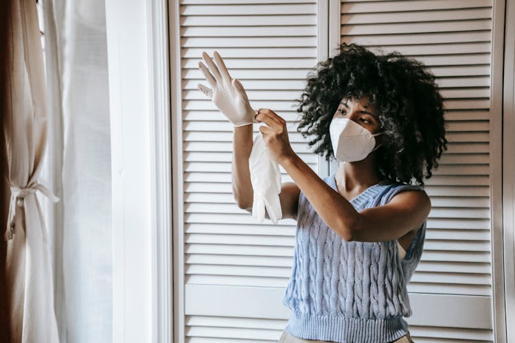 Black Woman Removing Rubber Gloves