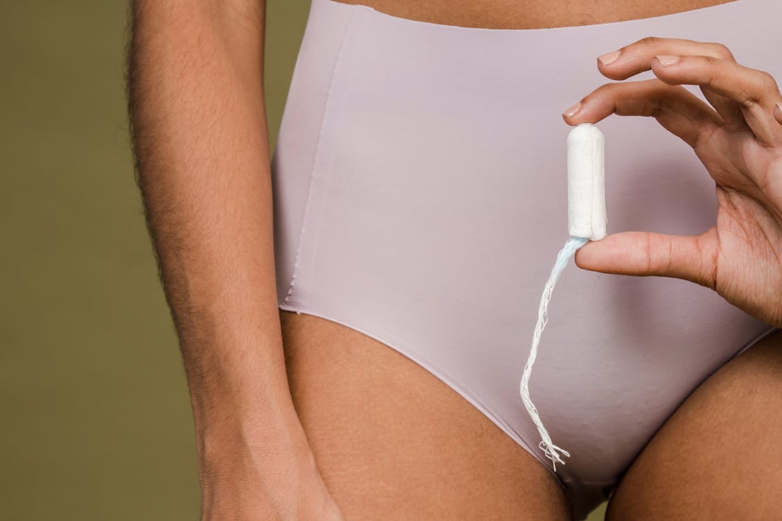 Woman in panties showing female tampon · Free Stock Photo