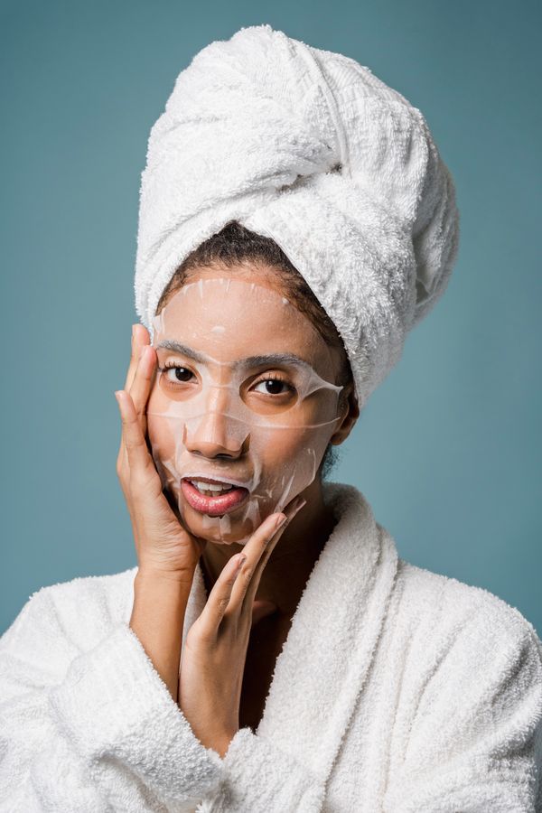 Woman in a white bathrobe with a towel on her head