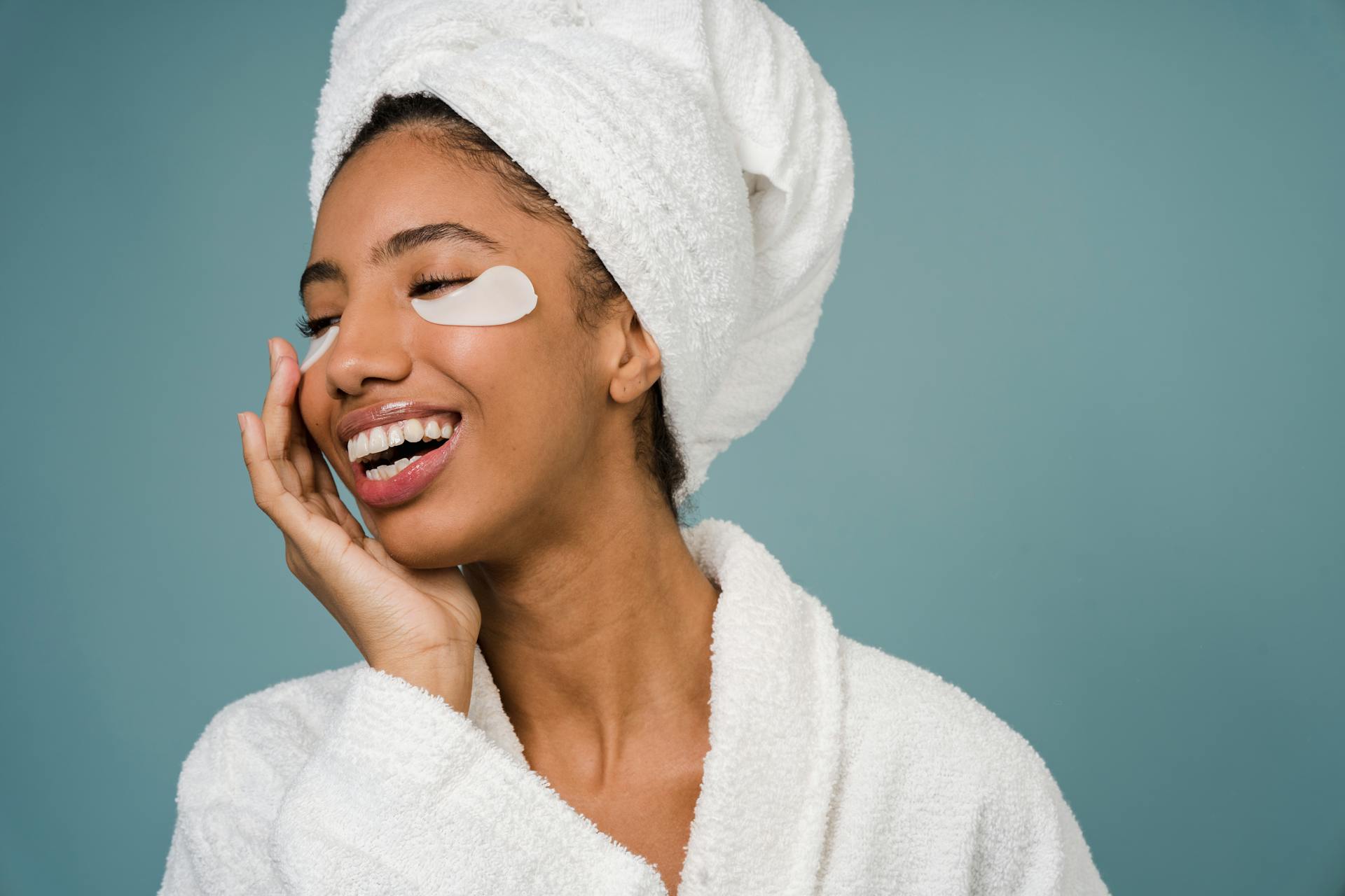 Cheerful black female with eye patches against blue background