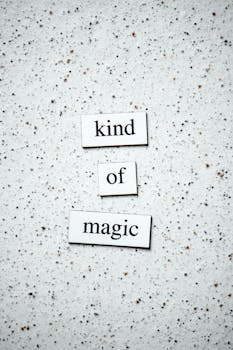 Inspirational text "kind of magic" on a neutral speckled background, perfect for motivational designs.