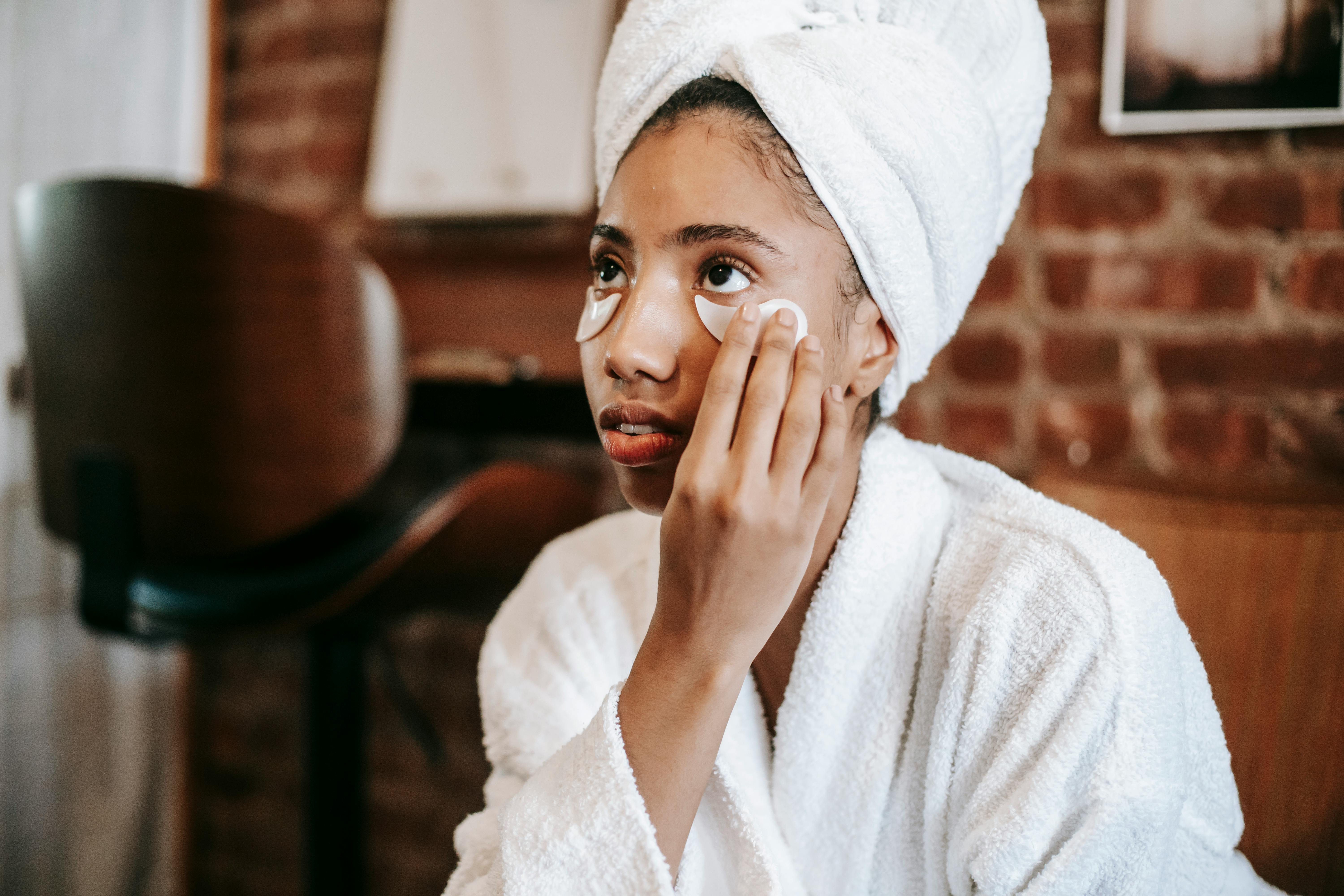 black woman applying facial patches on face