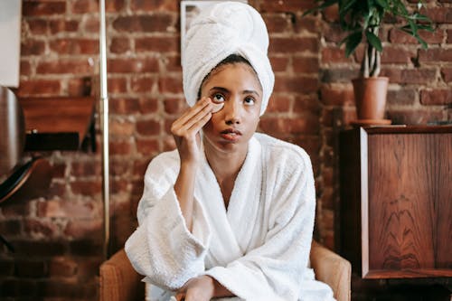 Free Black woman in bathrobe after shower Stock Photo