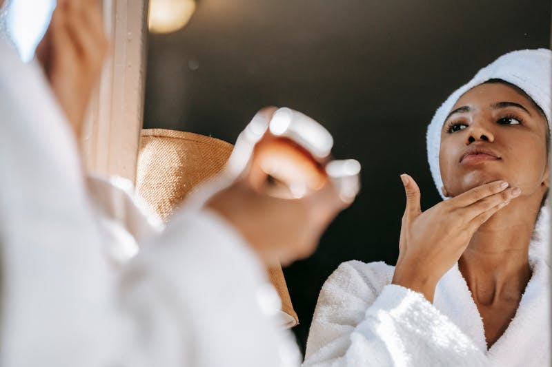 A woman applying face cream