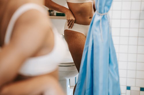 Ethnic woman showing body curves in bathroom