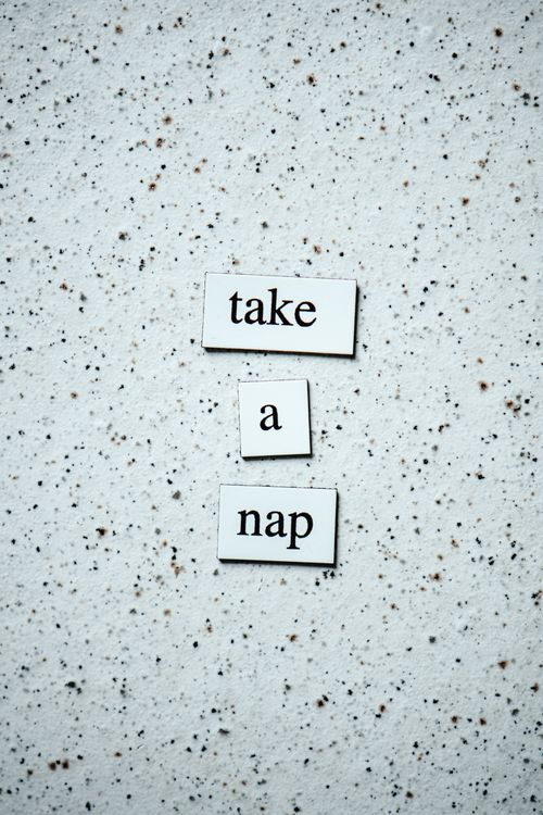 Free Tile art with 'take a nap' on a speckled surface, promoting relaxation vibes. Stock Photo
