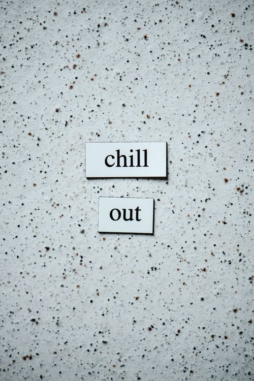 Free Simple text art with "chill out" on a speckled background. Stock Photo