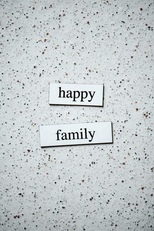 Free Simple text labels on a speckled surface reading 'happy family'. Stock Photo