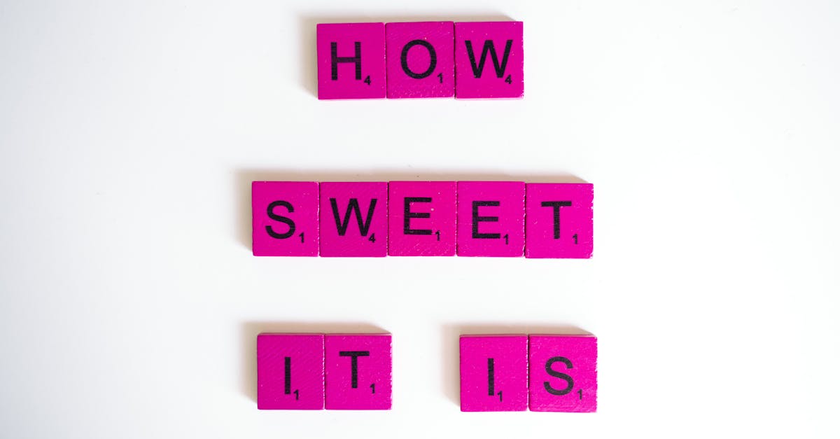 Bright pink Scrabble tiles spelling 'How Sweet It Is' on a white surface.