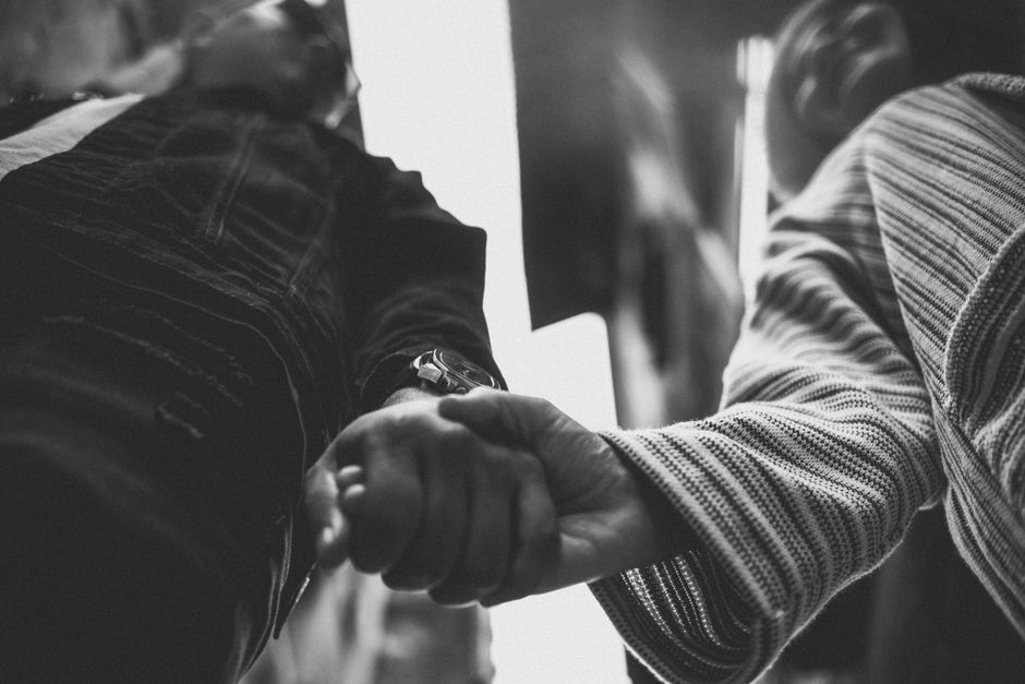 people holding hands in solidarity