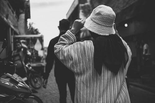 Man and Woman Walking in Grayscale Photography