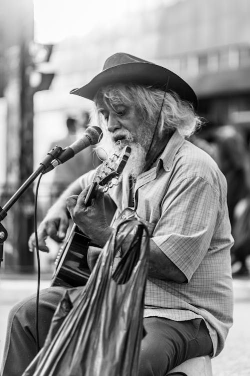 Man in Checkered Shirt Playing Guitar