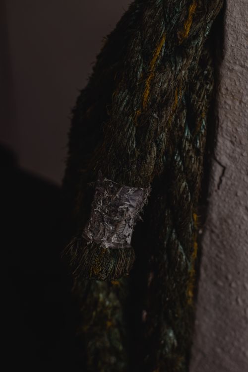 Free Close-up of weathered rope, showcasing its texture against a dark background. Stock Photo