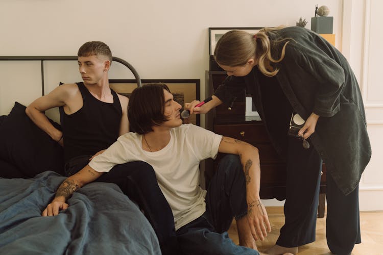 Woman Applying A Make Up To Man Inside A Bedroom 