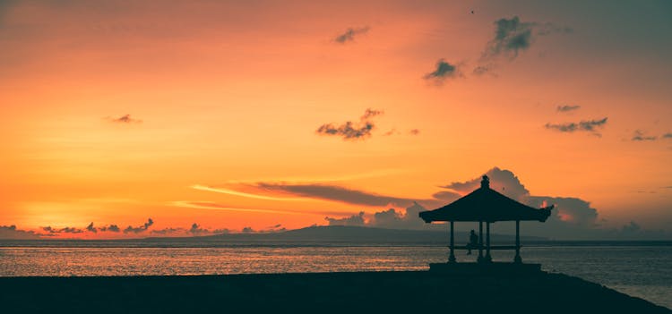 A Hut On A Beach At Sunset In Sanur, Bali 