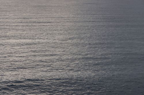 Free Calm ocean surface with gentle ripples under a twilight sky, creating a serene and peaceful atmosphere. Stock Photo