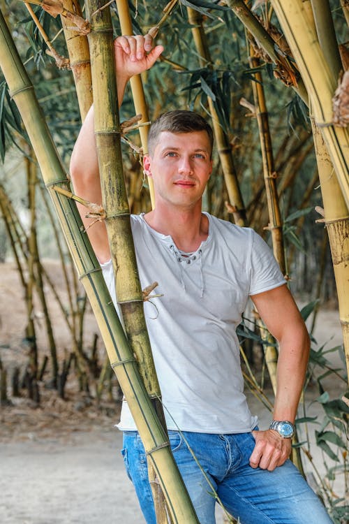 Fit young man standing confidently in tropical park