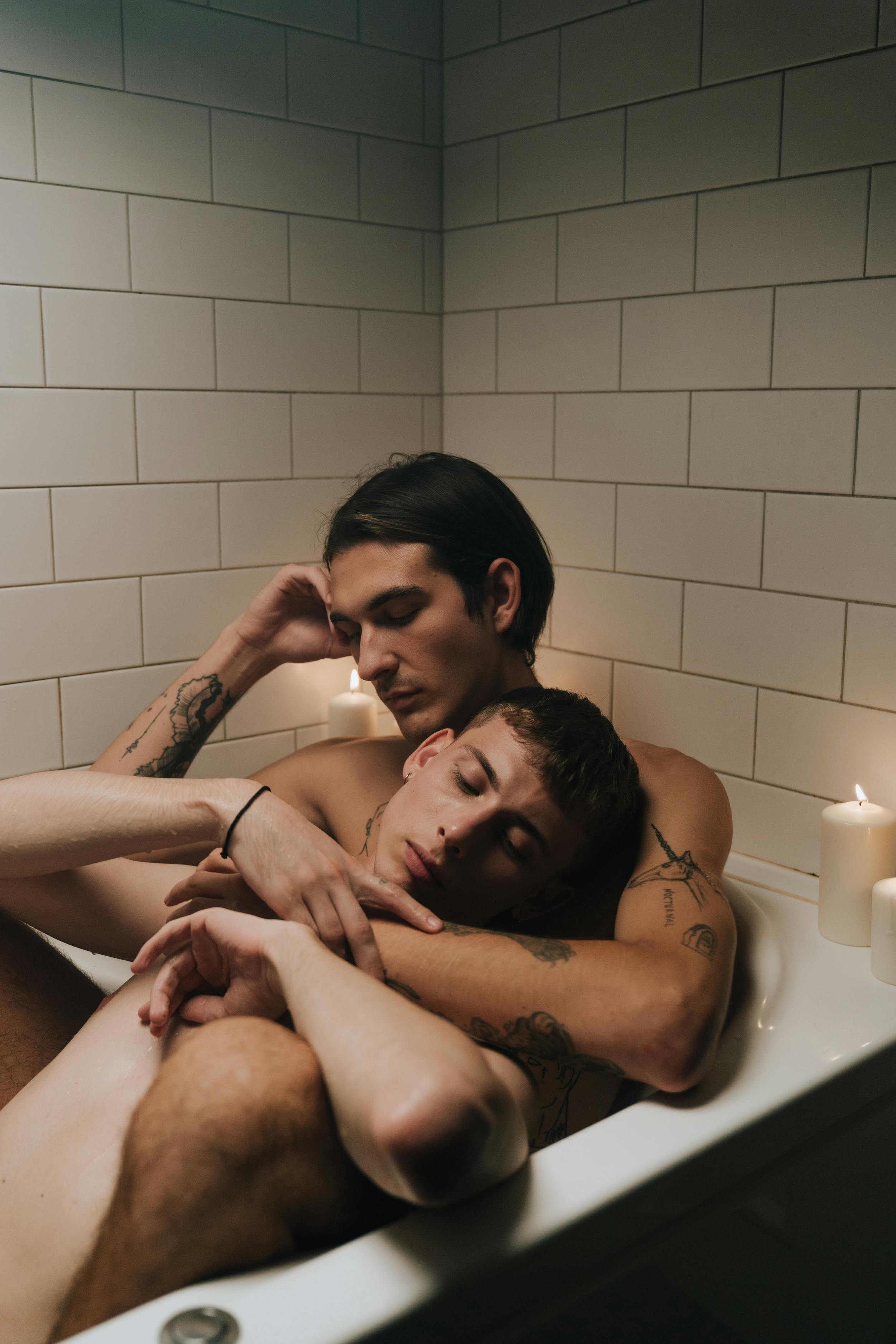 men hugging in a bathtub