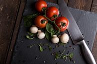 Red Tomatoes, Mushrooms, and Gray Steel Knife