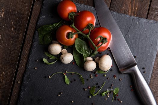 Red Tomatoes, Mushrooms, and Gray Steel Knife