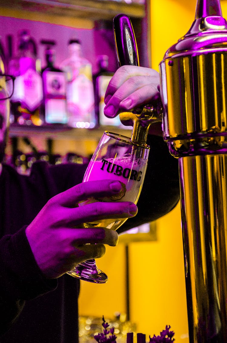 Crop Bartender Pouring Beer Into Glass