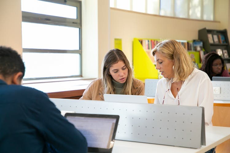 Diverse Students Doing Research With Teacher