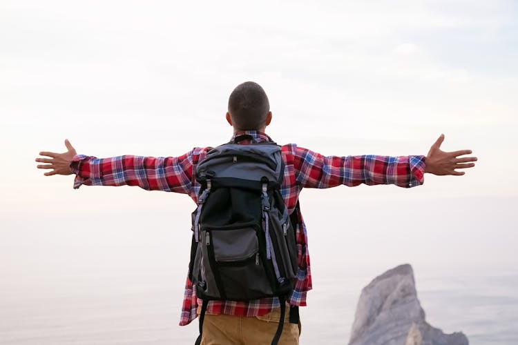 Man Standing While Arms Wide Open