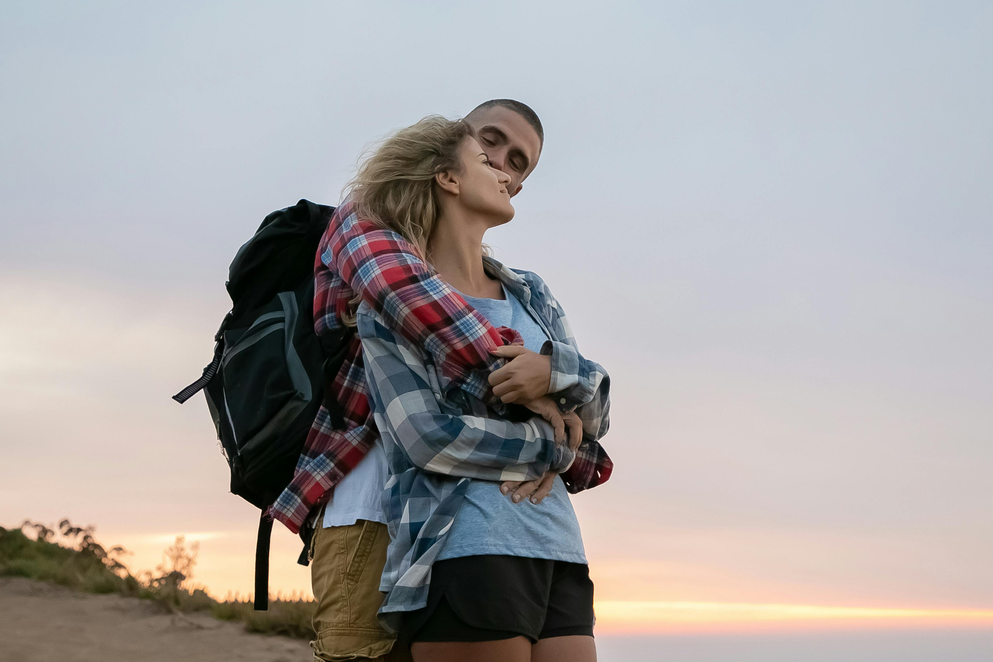 A couple sharing a romantic embrace during a sunset in scenic Portugal, exuding love and togetherness.