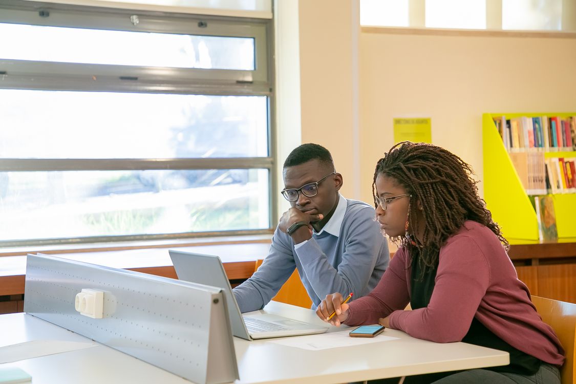 Students presenting their work in a university classroom
