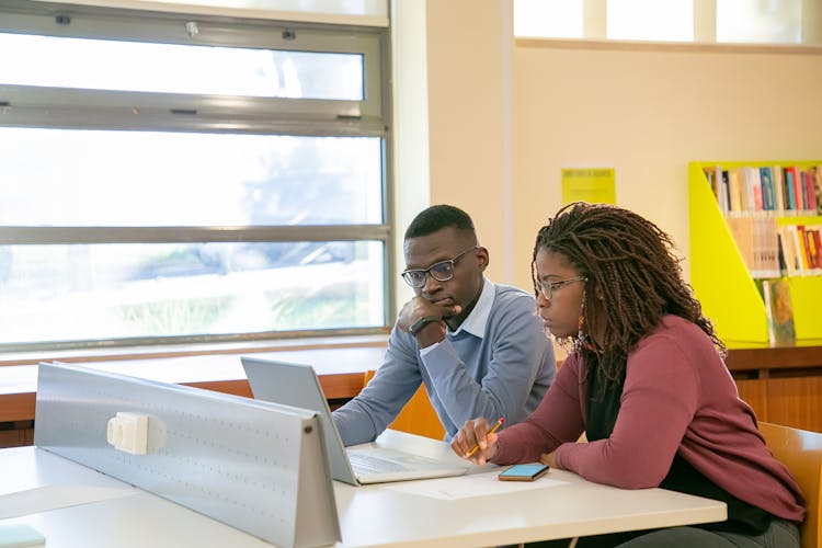 Black Couple Doing Presentation For Studies In Classroom