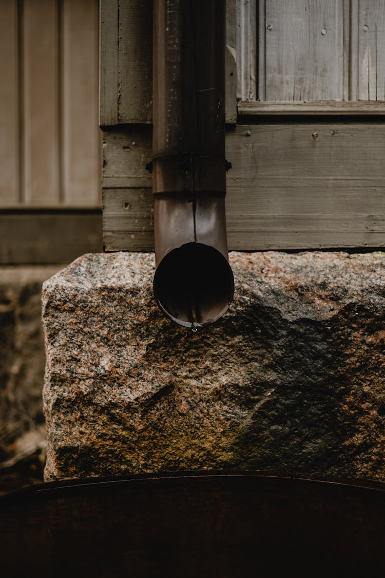 
A Close-Up Shot Of A Downspout