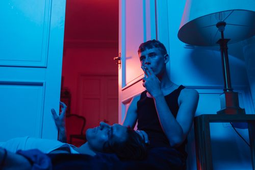 Free Two men in a dramatic indoor setting, with colorful moody lighting. Stock Photo