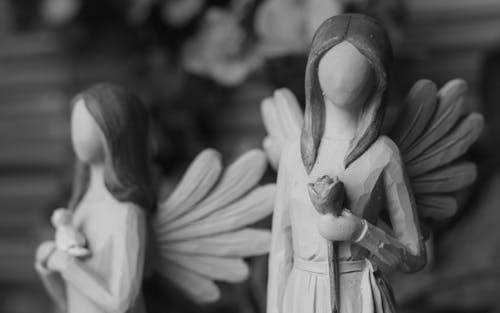 Free A Grayscale of Angel Figurines Stock Photo