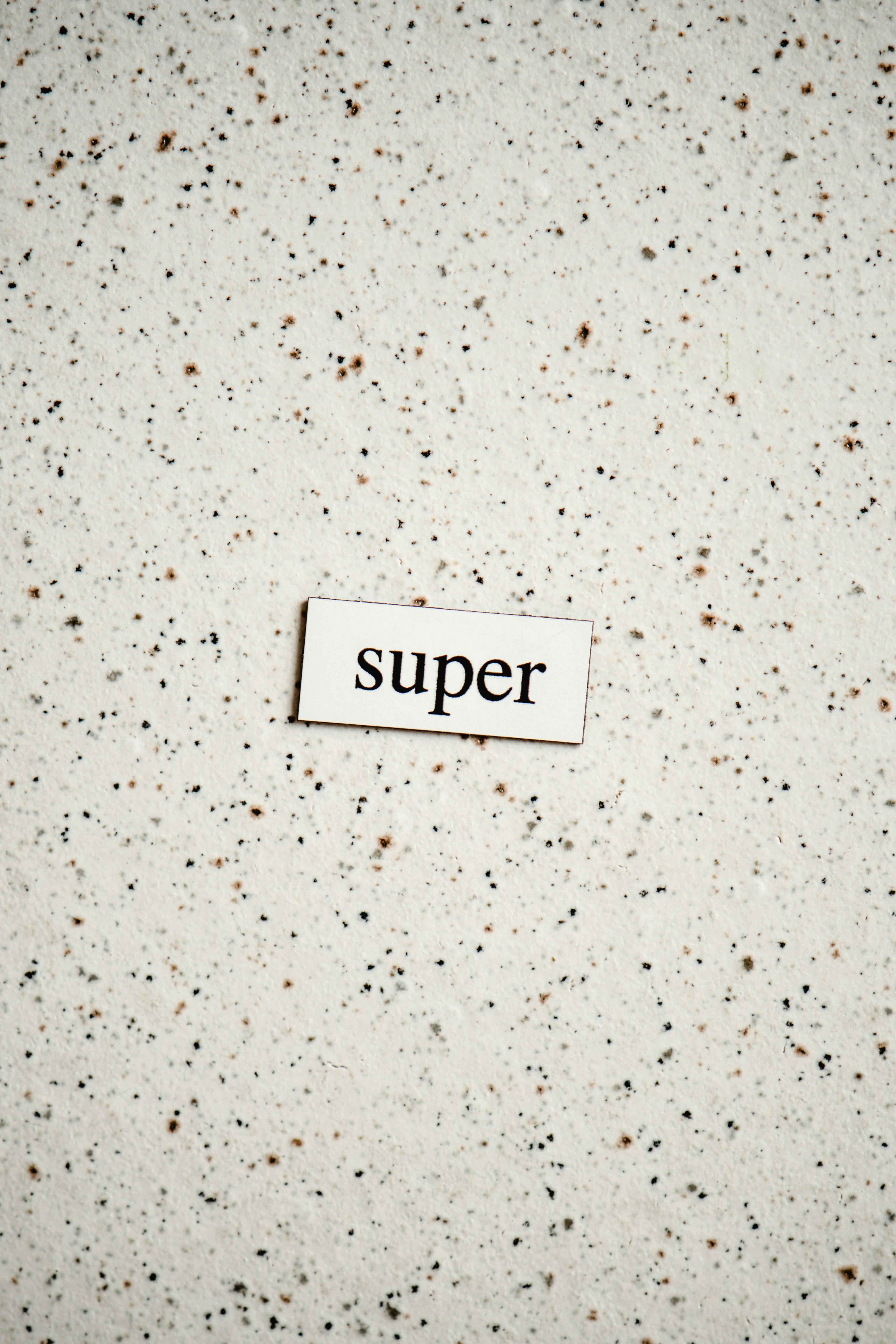 the word super cutout on a granite surface