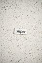 The Word 'Super' Cutout on a Granite Surface