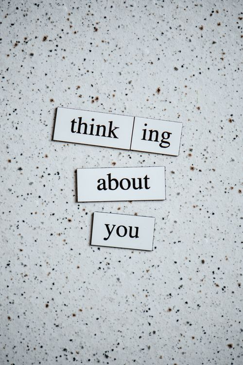 Free Simple textured background with words 'thinking about you' for creative projects or designs. Stock Photo