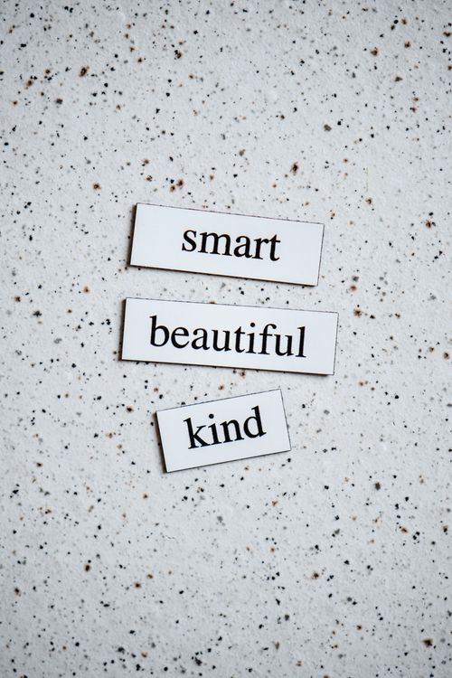Free Simple text on a speckled surface conveying a positive message with words 'smart', 'beautiful', 'kind'. Stock Photo