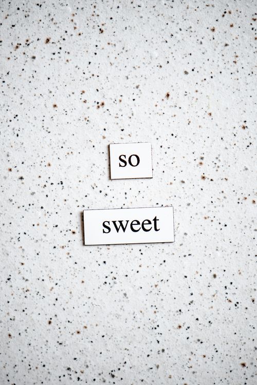 Free A simple 'so sweet' text art piece on a speckled white background, conveying a message of positivity. Stock Photo