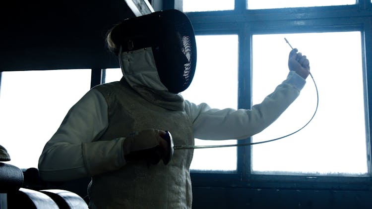 Person Wearing Epee Mask