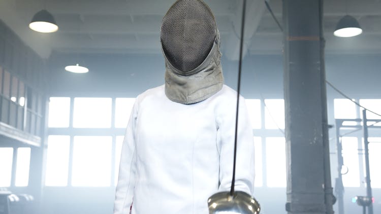 A Person Wearing Epee Mask