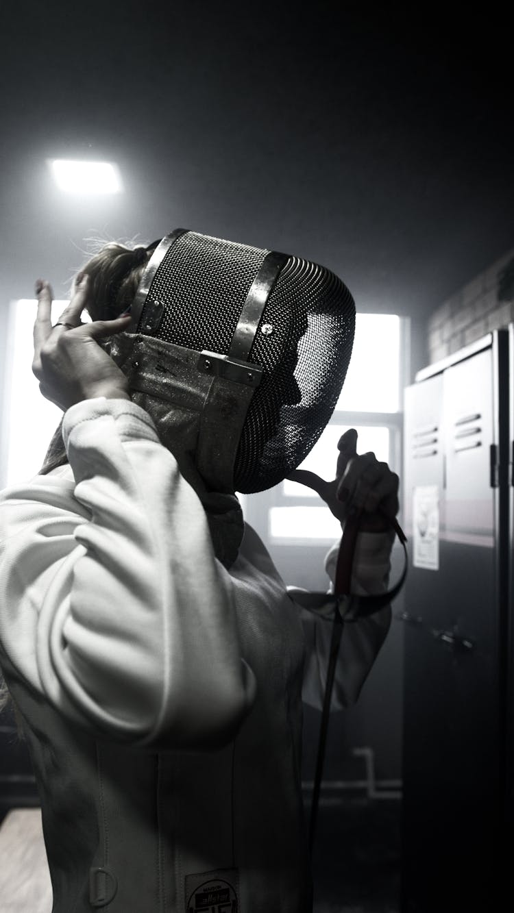 Person In White Coat Holding Black Leather Bag